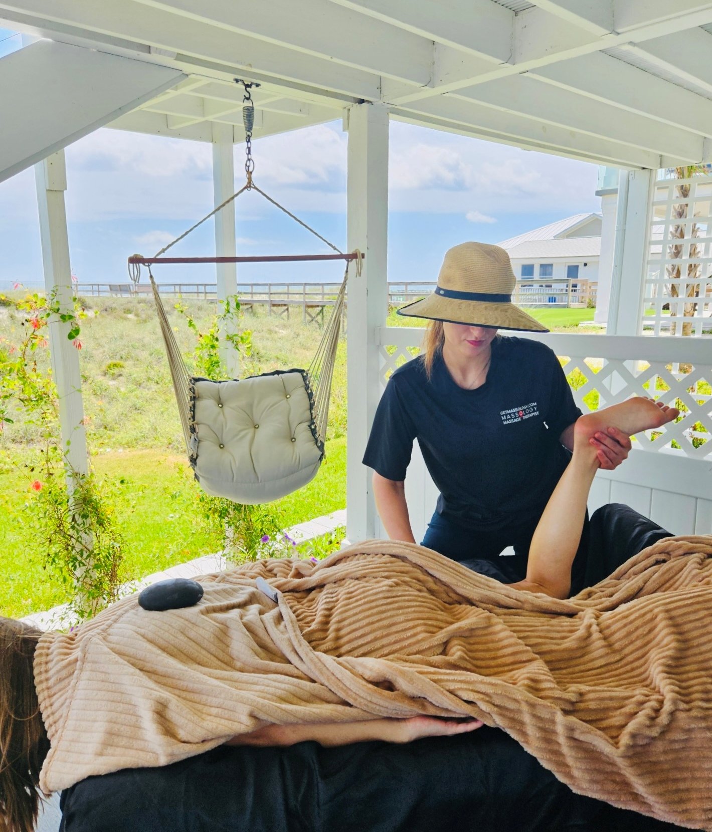 book a massage at home with Lina s. licensed massage therapist doing stretching and hot stone.